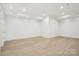 Spacious basement with hardwood flooring and recessed lighting, perfect for customization at 8813 Graham Rd, Denver, NC 28037