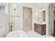 Bright bathroom shows a glass shower, elegant vanity, and large soaking tub at 8813 Graham Rd, Denver, NC 28037
