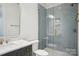 Stylish bathroom with a gray vanity, marble countertop, and sleek glass shower, showcasing a modern design at 8813 Graham Rd, Denver, NC 28037
