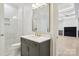 Elegant bathroom features a gray vanity with marble countertop and gold fixtures, plus a tiled walk-in shower at 8813 Graham Rd, Denver, NC 28037
