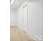 Bright hallway with hardwood floors and a white door at 8813 Graham Rd, Denver, NC 28037