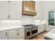 Gourmet kitchen featuring stainless steel oven, custom hood, and bright white countertops at 8813 Graham Rd, Denver, NC 28037