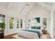 Bright main bedroom with vaulted ceilings, balcony access, and beautiful lake view at 8813 Graham Rd, Denver, NC 28037