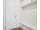 Bright mudroom features a bench with drawers and white cabinets for storing outerwear and accessories at 8813 Graham Rd, Denver, NC 28037