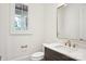 Elegant powder room offers a sleek mirror, modern vanity, and window for natural light at 8813 Graham Rd, Denver, NC 28037