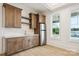 Wet bar features custom wood cabinets, quartz countertops, and a stainless steel refrigerator at 8813 Graham Rd, Denver, NC 28037