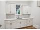 Charming wet bar with stylish cabinetry, designer backsplash, and modern sink fixtures at 8813 Graham Rd, Denver, NC 28037
