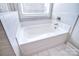 Clean, well-lit bathtub with modern fixtures and tile surround, providing a relaxing bathing space at 9007 Raven Top Dr, Mint Hill, NC 28227