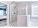 Modern bathroom with a glass-enclosed shower, soaking tub, and natural light from a nearby window at 9007 Raven Top Dr, Mint Hill, NC 28227