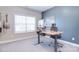 Bright office space with a large window and an adjustable sit/stand desk illuminated by natural light at 9007 Raven Top Dr, Mint Hill, NC 28227