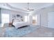 Bright primary bedroom with a ceiling fan, carpet, and an ensuite bathroom creating a relaxing retreat at 9007 Raven Top Dr, Mint Hill, NC 28227