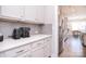 Butler pantry featuring white cabinets, light backsplash, and stainless steel appliances at 9007 Raven Top Dr, Mint Hill, NC 28227
