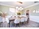 Elegant dining room featuring modern lighting, stylish decor, and neutral color palette at 9007 Raven Top Dr, Mint Hill, NC 28227