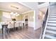 Open dining room with modern light fixture, stylish decor, and staircase at 9007 Raven Top Dr, Mint Hill, NC 28227