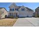 Charming two-story home featuring a three car garage and welcoming front porch at 9007 Raven Top Dr, Mint Hill, NC 28227