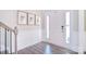 Bright foyer featuring a white front door, staircase, and stylish wood flooring at 9007 Raven Top Dr, Mint Hill, NC 28227