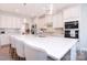 Beautiful kitchen with large center island, stainless steel appliances, and stylish pendant lighting at 9007 Raven Top Dr, Mint Hill, NC 28227