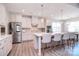 Modern kitchen with stainless steel appliances, large island, and seamless flow to dining space at 9007 Raven Top Dr, Mint Hill, NC 28227