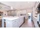 Spacious kitchen with white cabinetry, stainless steel appliances, and an open layout to living area at 9007 Raven Top Dr, Mint Hill, NC 28227