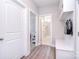 Bright mudroom with built-in bench, hooks, and storage cabinets, leading to bathroom and other rooms at 9007 Raven Top Dr, Mint Hill, NC 28227