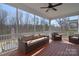 Relaxing screened porch with wicker furniture and a ceiling fan, offering a serene outdoor retreat at 9007 Raven Top Dr, Mint Hill, NC 28227