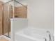 Luxurious bathroom featuring a tub, a glass shower enclosure, and elegant tile work at 9017 Lanark Ln, Fort Mill, SC 29707