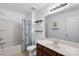 Well-lit bathroom featuring a tub, shower, floating shelves, and framed mirror at 9017 Lanark Ln, Fort Mill, SC 29707
