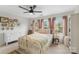 Comfortable bedroom featuring a vintage-style bed, complemented by soft pink curtains and ample natural light at 9017 Lanark Ln, Fort Mill, SC 29707