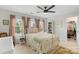 Spacious bedroom featuring a black ceiling fan, a comfortable bed, and a walk-in closet at 9017 Lanark Ln, Fort Mill, SC 29707