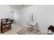 Bright bedroom featuring a vanity, sewing machine, and bookshelf at 9017 Lanark Ln, Fort Mill, SC 29707