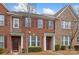 Classic brick townhome boasts manicured landscaping, and charming curb appeal at 9017 Lanark Ln, Fort Mill, SC 29707