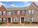 Inviting townhome with a brick exterior, neatly trimmed shrubs, and a welcoming front entrance at 9017 Lanark Ln, Fort Mill, SC 29707