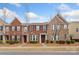 Charming townhome featuring a brick facade, well-maintained landscaping, and inviting curb appeal at 9017 Lanark Ln, Fort Mill, SC 29707
