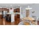 Bright kitchen with breakfast bar, stainless steel appliances, and open layout to the dining room at 9017 Lanark Ln, Fort Mill, SC 29707