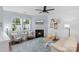 Cozy living room with fireplace, large windows, and comfortable seating area at 9017 Lanark Ln, Fort Mill, SC 29707