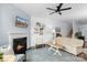 Spacious living room featuring a fireplace, ceiling fan, and neutral color scheme at 9017 Lanark Ln, Fort Mill, SC 29707