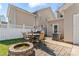 Backyard patio with brick pavers, seating, fire pit and white fencing creates a lovely outdoor space at 9113 Cinder Ln, Huntersville, NC 28078
