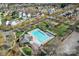 Aerial view of community pool, clubhouse, playground, and parking offers residents a complete recreational area at 9113 Cinder Ln, Huntersville, NC 28078