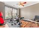 Well-lit workout room featuring exercise equipment, hardwood floors, and a ceiling fan for a comfortable exercise environment at 9113 Cinder Ln, Huntersville, NC 28078