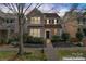 Charming two-story home featuring a welcoming front porch and beautifully landscaped front yard, virtually enhanced at 9113 Cinder Ln, Huntersville, NC 28078