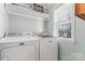 Bright laundry room features a Maytag washer and dryer, shelving and natural light from the window at 9113 Cinder Ln, Huntersville, NC 28078