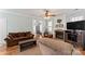 Cozy living room with a stone fireplace, hardwood floors, and comfortable seating at 9113 Cinder Ln, Huntersville, NC 28078