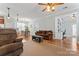 Spacious living room offering hardwood floors, comfortable seating, and access to a home office at 9113 Cinder Ln, Huntersville, NC 28078