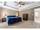 Spacious main bedroom with a trey ceiling, cozy carpet flooring, and ample natural light at 9113 Cinder Ln, Huntersville, NC 28078