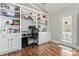 Bright office space with built-in shelving, desk area, hardwood floors, and a convenient outdoor exit at 9113 Cinder Ln, Huntersville, NC 28078
