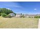Large, grassy backyard featuring well-maintained lawns and fenced property lines, providing a secure outdoor space at 9937 Travertine Trl, Davidson, NC 28036