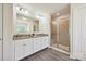 Bathroom featuring a double sink vanity, large mirror, and a glass-enclosed shower at 9937 Travertine Trl, Davidson, NC 28036