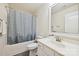Bathroom featuring a modern vanity, toilet, and shower and tub combo with patterned curtain at 9937 Travertine Trl, Davidson, NC 28036
