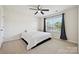 Bedroom featuring carpet, a ceiling fan, and a large window at 9937 Travertine Trl, Davidson, NC 28036