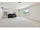 Spacious bonus room featuring neutral carpet, windows with blinds, and recessed lighting at 9937 Travertine Trl, Davidson, NC 28036